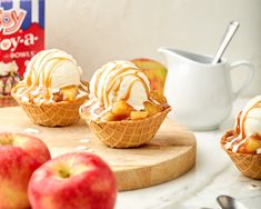 apples and ice cream are sitting on a cutting board