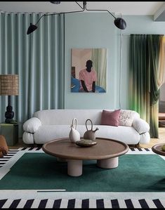 a living room filled with lots of furniture and walls covered in green draping