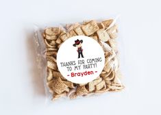 a bag filled with crackers sitting on top of a white table next to a sticker that says thank you for flying by