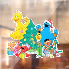 the sesame street christmas tree sticker is on display in front of a store window