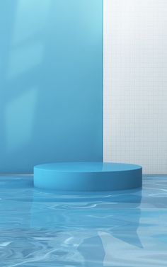 a round blue object sitting in the middle of a room with tile walls and floor