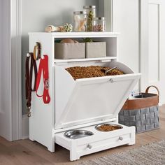 a dog food dispenser in the corner of a room with its door open