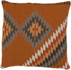 an orange and grey decorative pillow on a white background