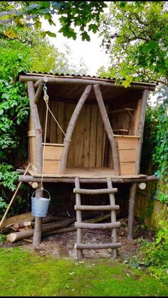 an outhouse made from logs in the yard