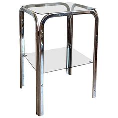 a chrome and glass side table with one shelf on the bottom, two shelves below