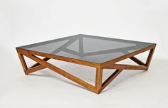 a coffee table with glass top and wooden frame on the bottom, against a white background