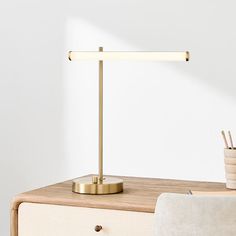 a desk lamp sitting on top of a wooden table