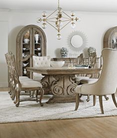 a dining room table with chairs and a chandelier