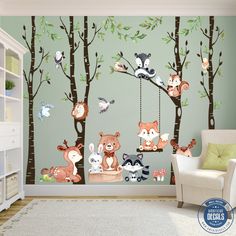 a child's room with woodland animals on the tree wallpaper and swing set