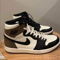 About This Product Featuring A Look Similar To Travis Scott's 2019 Air Jordan 1 Collaboration, The Air Jordan 1 Retro High Og 'Dark Mocha' Released In October 2020. The Shoe's Upper Is Built With Leather, Sporting A White Base Overlaid By Black Leather. The Heel And Collar Incorporate Dark Mocha Nubuck, While A Nylon Tongue And Perforations On The Toe Box Maintain The Classic Aesthetic. Air In The Heel Of The Midsole Provides Cushioning. Nike Brown Basketball Shoes With Boost Midsole, Nike Brown Basketball Shoes With Cushioned Footbed, Nike Brown Basketball Shoes, Nike Brown High-top Basketball Shoes, Brown Jordan Shoes With Boost Midsole For Streetwear, Nike Brown High-top Sneakers With Cushioned Footbed, Nike Brown Mid-top Custom Sneakers, Nike Brown High-top Sneakers With Round Toe, Brown Mid-top Custom Sneakers With Cushioned Footbed