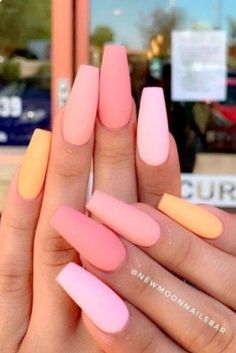 a woman's hand with pink and yellow nails