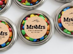 six tins filled with different colored candies