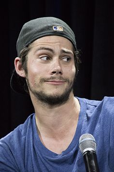 a man sitting in front of a microphone