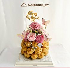 a birthday cake with flowers and butterflies on top