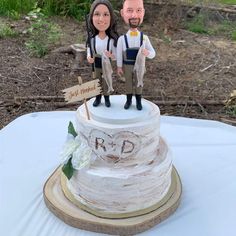 a wedding cake topper with a bride and groom figurine on it's stand