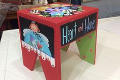 a red stool with the words heart and hubie painted on it