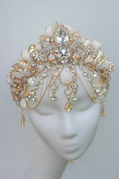 a white headpiece with lots of jewels on top of it's headband