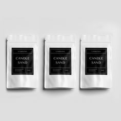 three bags of candle sand sitting next to each other