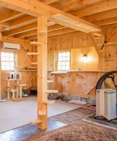 an unfinished room with wood paneling and lots of furniture