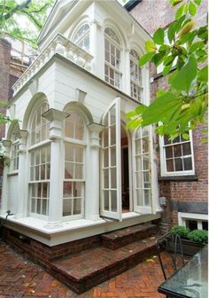 a white house sitting on top of a brick walkway