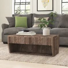 a living room with a couch, coffee table and rug on the floor in front of it