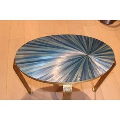 a blue and white coffee table sitting on top of a wooden floor