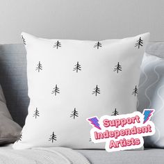 a pillow with the words support independent artists on it and trees in red, white, and blue