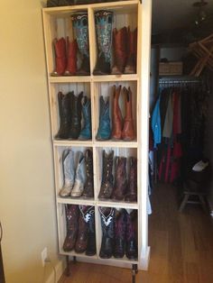 there are many pairs of cowboy boots on the shelves in this closet, all lined up