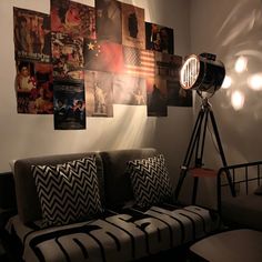 a living room with pictures on the wall and a couch in front of a projector