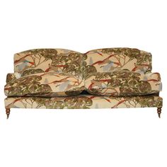 an upholstered couch with birds and trees on it