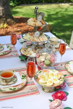 a table topped with plates and cups filled with food