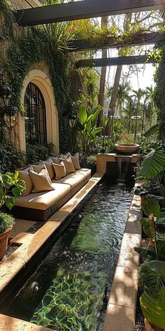 an outdoor living area with couches and water feature