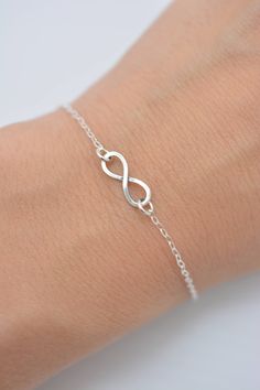 HAND-MADE OF SOLID STERLING SILVER PARTS - A GREAT KEEPSAKE I make this beautiful bracelet using a tiny 1/2 inch sterling silver infinity charm with an antiqued finish. Set on sterling silver chain, this bracelet secures with a lobster clasp. Each comes in a gift box, perfect for gift-giving. These make great group gifts. SIZING - IMPORTANT: To determine bracelet size, measure around your wrist and add 1/2 inch to get your bracelet size. Do not order in your exact wrist measurement as it will NO Simple Silver Jewelry For Friendship, Simple Hypoallergenic Sterling Silver Bracelets, Hypoallergenic Sterling Silver Infinity Jewelry, Hypoallergenic Infinity Sterling Silver Jewelry, Minimalist Silver Infinity Bracelet, Sterling Silver Infinity Bracelets For Everyday, Sterling Silver Infinity Bracelet For Everyday, Elegant Sterling Silver Charm Bracelet For Friendship, Elegant Sterling Silver Friendship Charm Bracelet