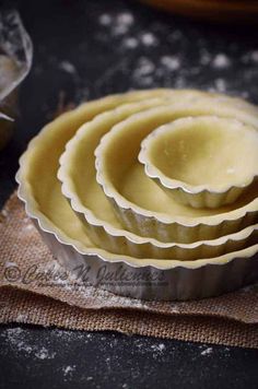 a stack of pie pans sitting on top of a table next to each other