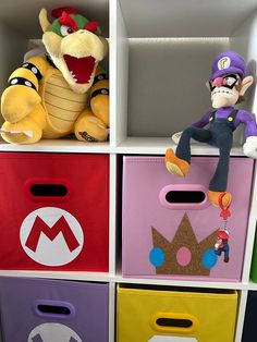 the toy storage bins are decorated with super mario and luigi's stuffed animals