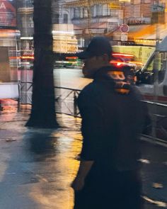 a man walking down the street in the rain