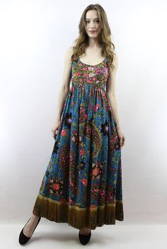 Vintage 60s 70s Blue Psychedelic Floral Hippie Festival Maxi Dress with Gold Fringe, fits size XS Multicolor Long Hippie Dress, Retro Multicolor Maxi Dress With Vibrant Print, Hippie Multicolor Maxi Dress, Multicolor Hippie Maxi Dress, Hippie Multicolor Floral Print Dresses, Multicolor Bohemian Dresses With Vintage Print, Bohemian Multicolor Dress With Vintage Print, Multicolor Boho Print Hippie Dress, Multicolor Midi Boho Dress For Festival