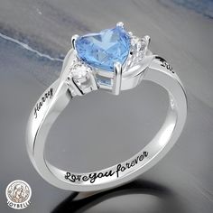 a heart shaped blue topazte ring with the words love you forever written on it