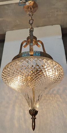 a chandelier hanging from the ceiling in a room with white walls and flooring