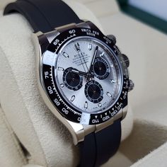 Remarkably beautiful Rolex Cosmograph Daytona in white gold with silver/black dial and ceramic bezel. This timepiece needs no introduction and is well known among Rolex enthusiasts and alike. The white gold is truly amazing on this watch which paired very nicely with ceramic bezel and proprietary Rolex oysterflex rubber. This timepiece features manufacture caliber 4130 with approximate power reserve of 72hrs. This timepiece comes mounted on E/G-E straps with additional .5 extension in clasp. Luxury White Watches With Analog Display, Luxury Silver Chronograph Watch With Analog Display, Luxury White Watch Accessories With Analog Display, Luxury White Chronograph Watch With Analog Display, Luxury White Gold Analog Watch, Rolex Cosmograph Daytona, Cosmograph Daytona, Bell & Ross, Ulysse Nardin