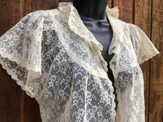 This elegant lace bolero is a unique layering piece, perfect for the bedroom, or as a dramatic addition to any outfit. No tags - estimated size small to medium . In good vintage condition.  19" armpit to armpit 18" length Vintage Lace Top With Ruffles, Vintage Lace Top With Ruffles For Spring, Vintage Lace Top With Lace Trim For Spring, Vintage Ruffled Lace Top For Spring, Spring Vintage Lace Top With Lace Trim, Sheer Lace Blouse For Daywear, Vintage Lace Blouse For Spring, Vintage Lace Patchwork Top For Spring, Vintage Lace Top For Spring