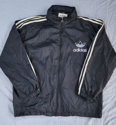 Vintage 1990s Adidas Black White Mesh Lined Tuck Away Hood Trefoil Windbreaker In great condition  Light normal staining white stripes Medium  Also fits a slim Large 28.5 x 26.5 Pit to Pit  Any questions feel free to reach out! Trashy 2000s, Jacket Adidas, Adidas Vintage, Adidas Windbreaker, Sun Valley, White Mesh, Adidas Black, Black Adidas, Adidas Jacket