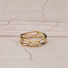 a gold ring sitting on top of a white surface