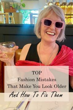 a woman sitting at a table with a drink in her hand and the words top fashion mistakes that make you look older and how to fix them