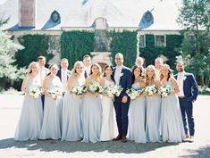 a group of people standing next to each other in front of a building