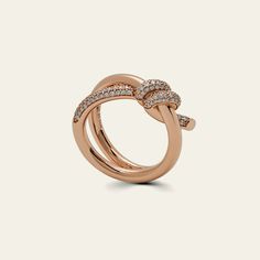 Tiffany & Co. Knot Double Row Ring in Rose Gold with Diamonds The Tiffany & Co. Knot ring tells a story about the strength of human connections through its entwined design. Each round brilliant diamond, carefully chosen to meet Tiffany's high standards, is set by hand at precise angles to make it sparkle. With a total carat weight of 0.31, this 18k rose gold ring is a stunning piece. You can wear it on its own for a bold statement or pair it with classic styles for a unique look. Details Conditi Tiffany Melody Ring, Knot Ring, High Standards, Watch Necklace, Brilliant Diamond, Ring Bracelet, 18k Rose Gold, Pave Diamonds, Tiffany & Co.