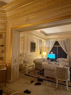 a living room filled with furniture and a flat screen tv sitting on top of a table