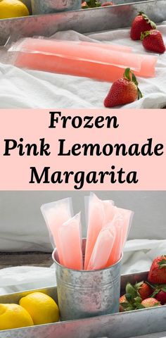 frozen pink lemonade margarita in a metal container with strawberries and lemons on the side