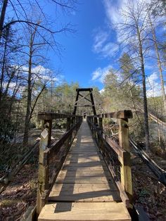 a wooden bridge in the middle of a forest