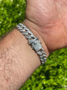 Men's 8" long 12mm wide bracelet made with iced moissanite stones
 
  
PASSES DIAMOND TESTER!!! ANY PEN OR LIGHT TRANSMISSION DIAMOND TESTER (Will show up as moissanite and not diamond on lab assays however)
4.1-4.5ct genuine D Color VVS1 moissanite..SO ICY THEY WILL BLIND YOU!
Comes with GRA certificate
 
 
*Also in available in 7" (if you need shorter length message us in checkout comments or we will ship 8" as default)
 
  
Heavy 36 grams
Su Luxury Diamond White Cuban Link Bracelets, Luxury Diamond White Cuban Link Bracelet, Luxury Diamond Cuban Link Bracelet For Anniversary, Luxury Diamond Cuban Link Bracelet With Solid Links, Luxury White Gold Sterling Silver Cuban Link Bracelet, Luxury Iced Out Diamond Cuban Link Bracelet, Luxury Iced Out Cuban Link Diamond Bracelet, Luxury Sterling Silver Cuban Link Bracelet For Men, Luxury Diamond Cuban Link Bracelet With Solid Link Construction